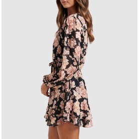 Model wearing Forever New Jasmine Skater Dress in gold floral print, featuring sheer long sleeves with elasticated cuffs and tiered mini skirt