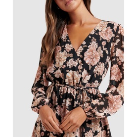 Model wearing Forever New Jasmine Skater Dress in gold floral print, featuring V-neck, sheer blouson sleeves and elasticated waist tie