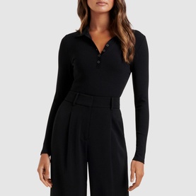 Model wearing Forever New Julia Long Sleeve Polo Top in black, fitted jersey fabric with polo collar and button-through front