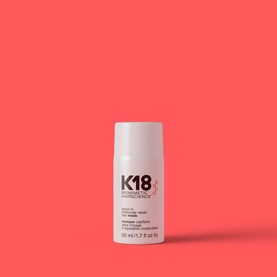 K18 Leave-In Molecular Repair Hair Mask 50ml in white tube against coral-pink background