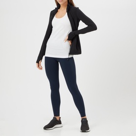 Model wearing Lululemon Swiftly Tech Racerback Tank Top in white, styled with black zip jacket, navy leggings and black trainers