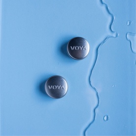 Voya Balmelicious Peppermint & Vanilla Organic Lip Balm, two silver compact tins on a wet light blue surface