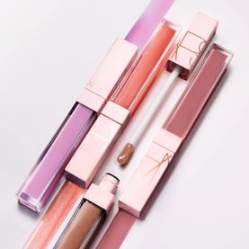 Nars Lip Shine Lip Gloss in Triple X, three shades shown in pink packaging including lilac, nude pink, and bronze tones
