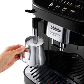 Delonghi Magnifica Evo Automatic Coffee Maker in black, hand steaming milk using integrated steam wand with silver frothing jug