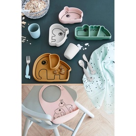 Done By Deer Ozzo Stick & Stay Bowl in light pink silicone, shown in lifestyle scene with matching tableware set on highchair tray