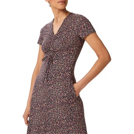 Model wearing Hobbs Simmy Dress in blue, all-over animal print, V-neckline, short sleeves, gathered front tie detail