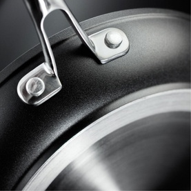 Stellar Rocktanium Non-Stick Frying Pan close-up showing grey PFOA-free QuanTanium surface and riveted stainless steel wishbone handle detail