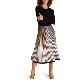 Model wearing Phase Eight Silvia Fit And Flare Dress in multi, featuring black bodice and pleated ombre stripe skirt, styled with tan ankle boots
