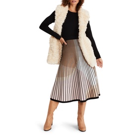 Model wearing Phase Eight Silvia Fit And Flare Dress in multi, styled with a cream faux fur gilet and tan ankle boots