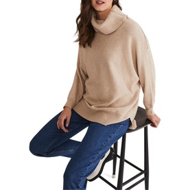 Model wearing Phase Eight Nola Zip Neck Chunky Relaxed Sweater in cream with cowl neck and relaxed fit, styled with blue jeans