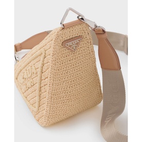 Prada Accessories Raffia Triangle Bag in brown straw with silver hardware, embroidered triangle logo, and detachable webbing shoulder strap