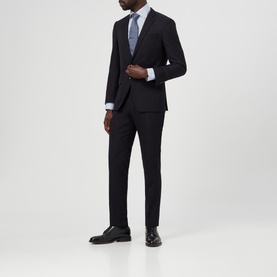 Model wearing Eton Bengal Striped Regular Fit Shirt in blue, styled with a dark navy suit, grey tie, and black Oxford shoes