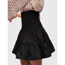 Model wearing Maje Jun Smock Ruffle Mini Skirt in black, elasticated smock waist, tiered ruffle hem, styled with floral top