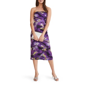 Model wearing Phase Eight Adelita Abstract Print Dress in purple floral pattern, styled with white strappy heels and a white clutch bag