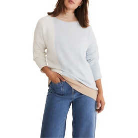 Model wearing Phase Eight Mariella Cosy Asymmetric Sweater in blue colour block with high neck and ribbed trims, styled with wide-leg jeans