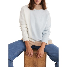 Model wearing Phase Eight Mariella Cosy Asymmetric Sweater in blue colourblock with high neck and ribbed trims, styled with blue jeans