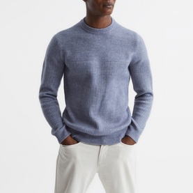 Model wearing Reiss Marcus Crew Ribbed Sweater in blue, with cream trousers. Crew neck, long sleeves, textured ribbed detail