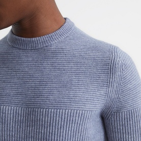 Model wearing Reiss Marcus Crew Ribbed Sweater in blue, showing textured ribbed knit detail and mock crew neckline close-up