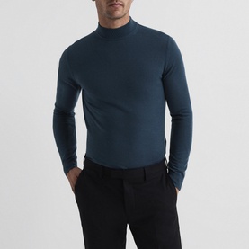 Model wearing Reiss Kelby Turtleneck Sweater in blue wool with ribbed trims, styled with black tailored trousers