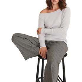 Model wearing Phase Eight Sienna Wool Cashmere Asymmetric Sweater in grey with slash neckline, styled with grey pinstripe wide-leg trousers