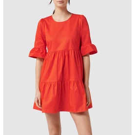 Model wearing Forever New Matilda Cotton Smock Dress in red with frill cuffs, tiered skirt, and round neck