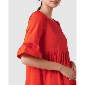 Model wearing Forever New Matilda Cotton Smock Dress in red, featuring frill cuffs and gathered bodice detail