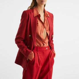 Model wearing Reiss Lola Double Breasted Blazer in red, styled with matching red trousers and a coral satin shirt