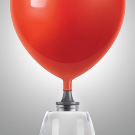 FAO Schwarz Rocket Ship Reaction Chamber science toy shown inflating a red balloon using a clear chamber vessel