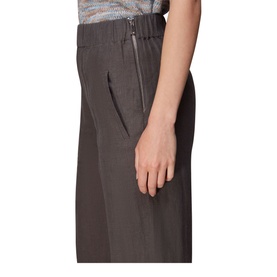 Model wearing Whistles Linen Trousers in black, high rise wide leg with zip fastening detail, styled with patterned top