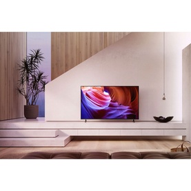 Sony Bravia 65 Inch 4K UHD X89K Google TV in black, styled in a modern living room with minimalist white shelving and plant d&eacute;cor