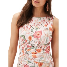 Model wearing Phase Eight Larna Blush Jackie Dress in pink floral print, sleeveless with ruched detailing and round neck. Drop earrings visible