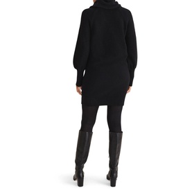 Model wearing Phase Eight Dahlie Cowl Neck Dress in black, long sleeve relaxed fit knit, styled with black knee-high boots. Rear view
