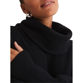 Model wearing Phase Eight Dahlie Cowl Neck Dress in black, close-up of cowl neck and ribbed trim detail, styled with gold hoop earring