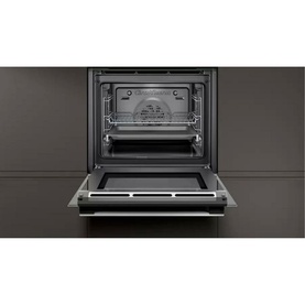 Neff T27DS79N0 built-in oven in black, shown open with interior racks visible, set into dark cabinetry