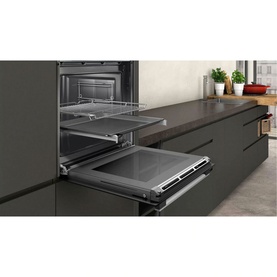 Neff T27DS79N0 75cm Black Gas Hob shown installed in a dark grey fitted kitchen, with oven below and pull-out rack extended