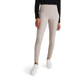 Model wearing Phase Eight Amina Jeggings in brown with exposed side zip, styled with white trainers and black top