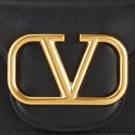 Valentino V Logo Chain Small Shoulder Bag in black leather, close-up of gold-tone VLogo signature hardware on flap closure