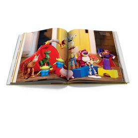 Assouline Mattel: 70 Years of Innovation and Play hardback book open to a page featuring Toy Story character figurines