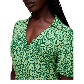 Model wearing Whistles Leopard Petals Midi Dress in green, close-up showing V-neck collar and short sleeve leopard floral print detail