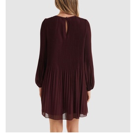 Model wearing Forever New Anna Pleat Mini Dress in Green, rear view showing keyhole button back, pleated blouson sleeves and full pleated skirt