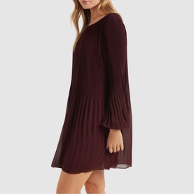 Model wearing Forever New Anna Pleat Mini Dress in green with pleated bodice, blouson sleeves, and flared skirt silhouette
