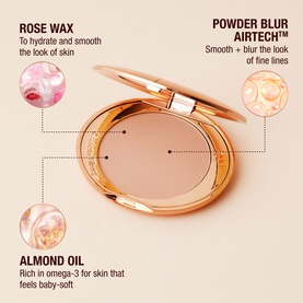 Charlotte Tilbury Airbrush Flawless Finish pressed powder compact open in rose gold case, with ingredient callouts: Rose Wax, Almond Oil, Powder Blur