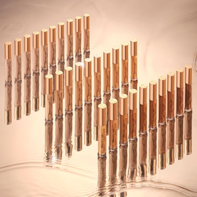 Charlotte Tilbury Beautiful Skin Radiant Concealer displayed in multiple shades, arranged in two diagonal rows on a peach reflective surface