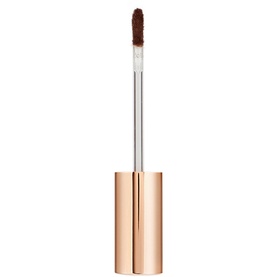 Charlotte Tilbury Beautiful Skin Radiant Concealer in deep brown shade, shown with applicator wand, gold cylindrical packaging, 7.2g