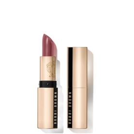 Bobbi Brown Luxe Lipstick in Bahama Brown, a muted mauve-brown bullet, shown with gold cap beside gold tube