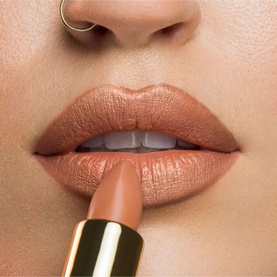 Model with KASH BEAUTY Secret Treasure Lipstick in True Nude shade applied to lips, shown with gold-toned bullet casing