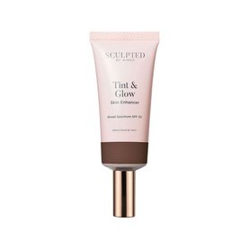 Sculpted by Aimee Tint & Glow Skin Enhancer tinted moisturiser in deep brown shade, pump tube with rose gold cap