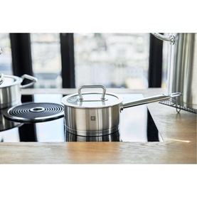 Zwilling PRO 16cm Stainless Steel Saucepan with glass lid on induction hob, satin-finished silver body with side handle