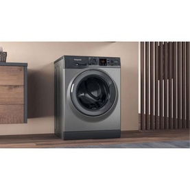 Hotpoint 8kg Freestanding Washing Machine in graphite grey, front-loading with dark drum and digital control panel, styled in modern laundry room