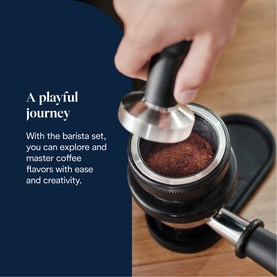 DeLonghi La Specialista Arte Coffee Machine lifestyle shot showing a hand tamping ground coffee into a portafilter on a dark surface.